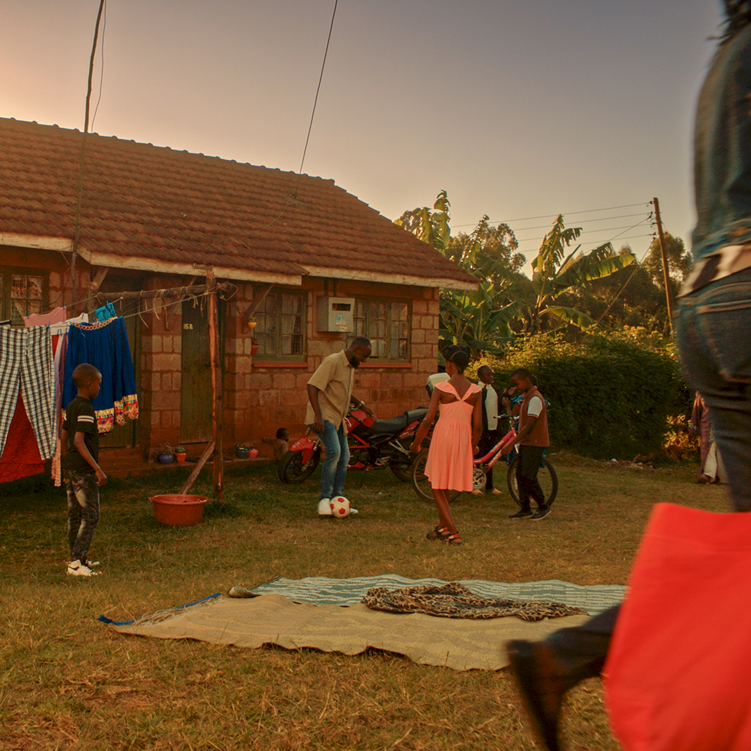 Family playing football outside their home