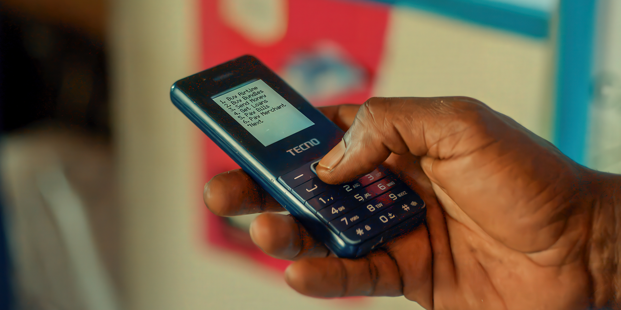 Man using his mobile phone to organise a microloan for seed purchase