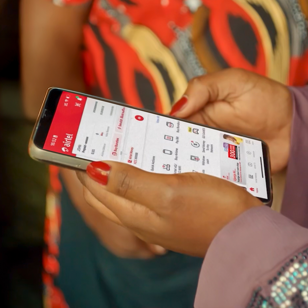 Woman purchasing fruit and vegetables at market using mobile device