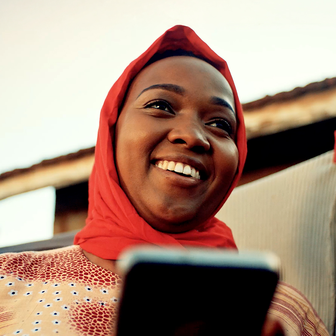 Women using her mobile phone to transfer money to her family
