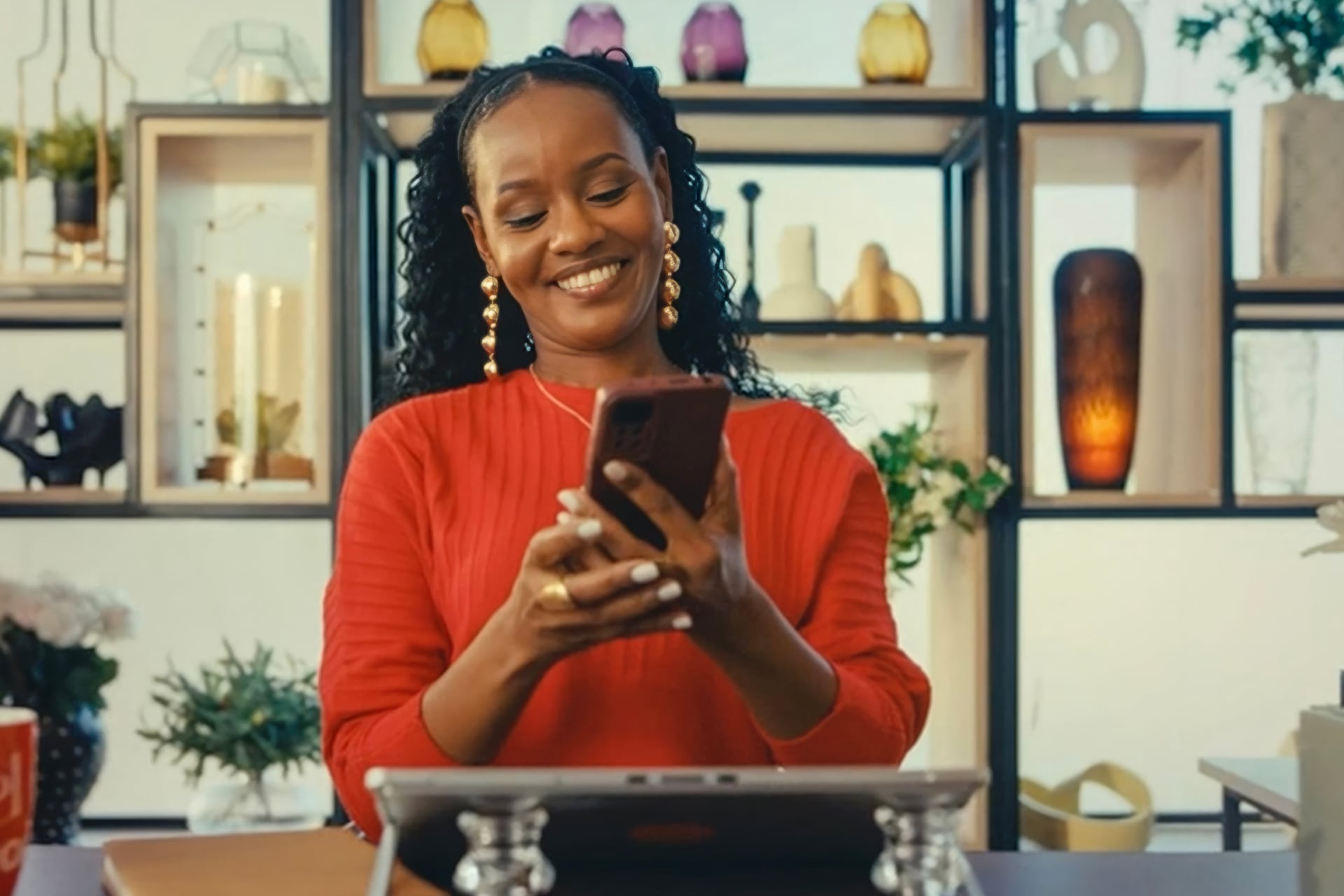 Woman smiling while looking at her phone