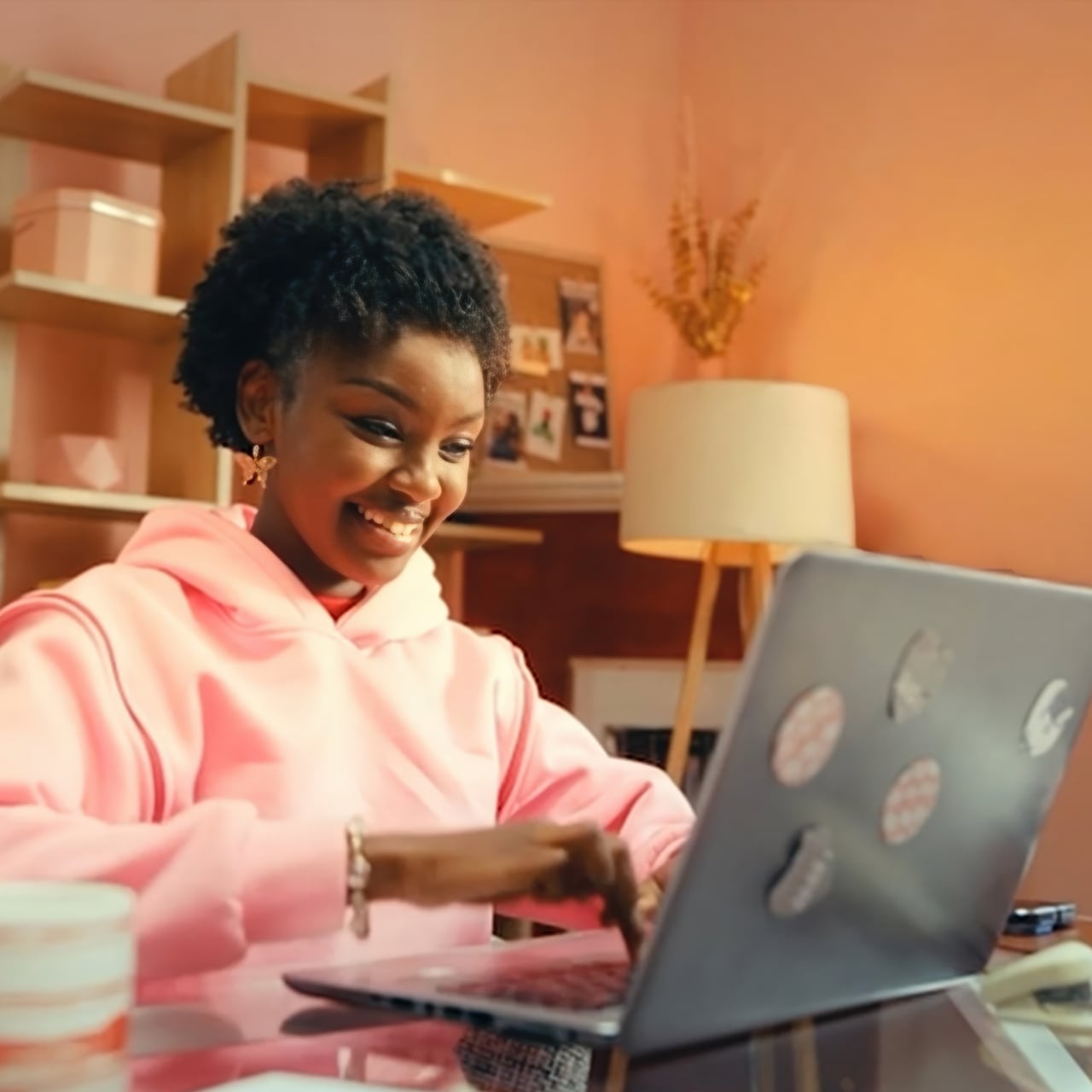 Woman smiling while typing on her laptop