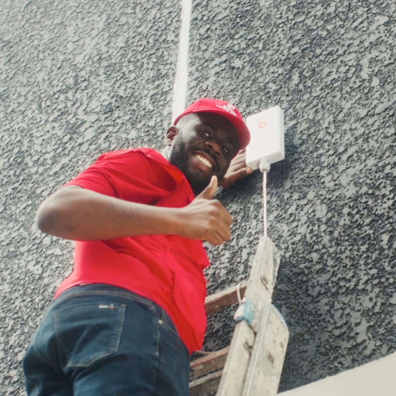 Man up ladder installing an Airtel product
