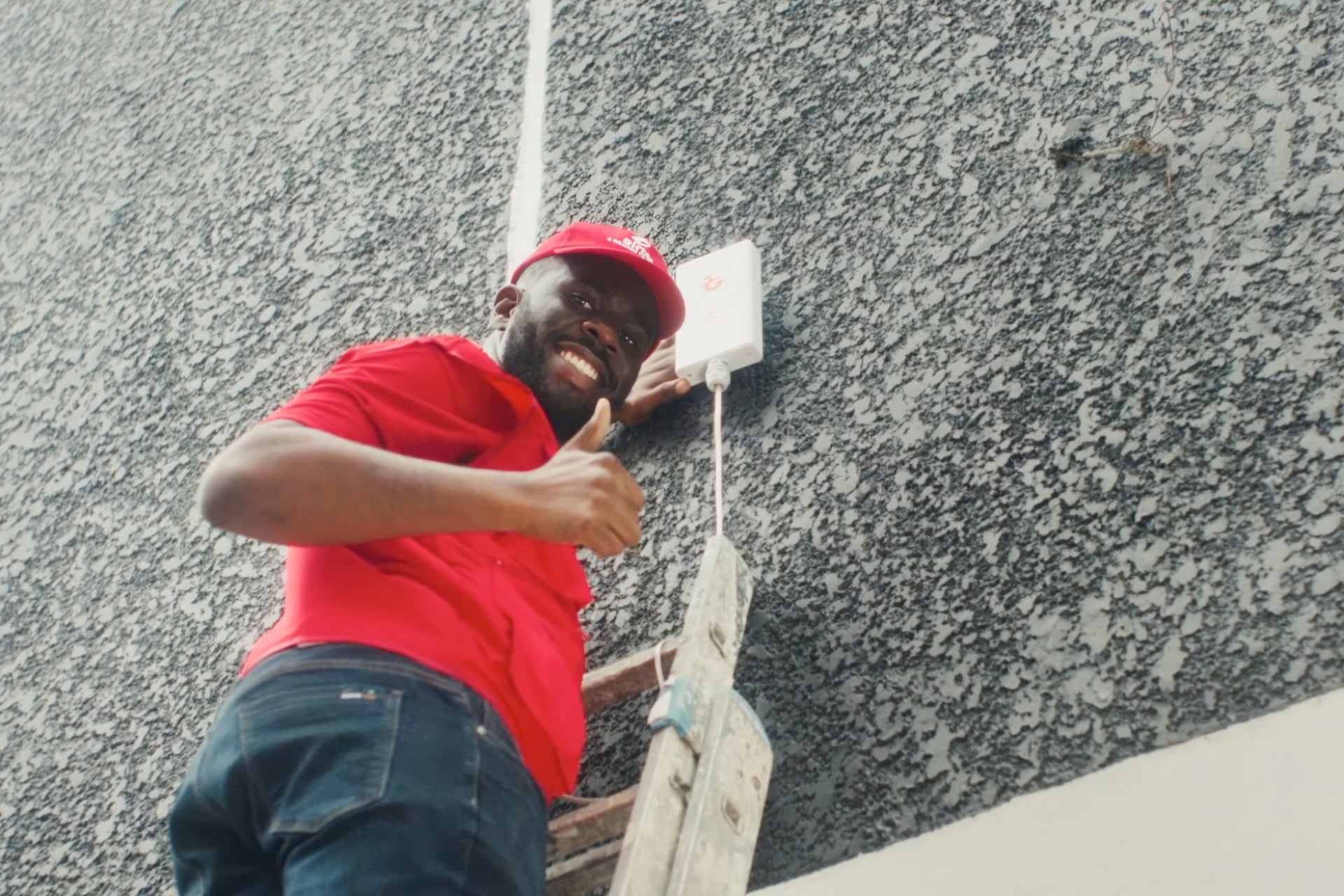 Man up ladder installing an Airtel product