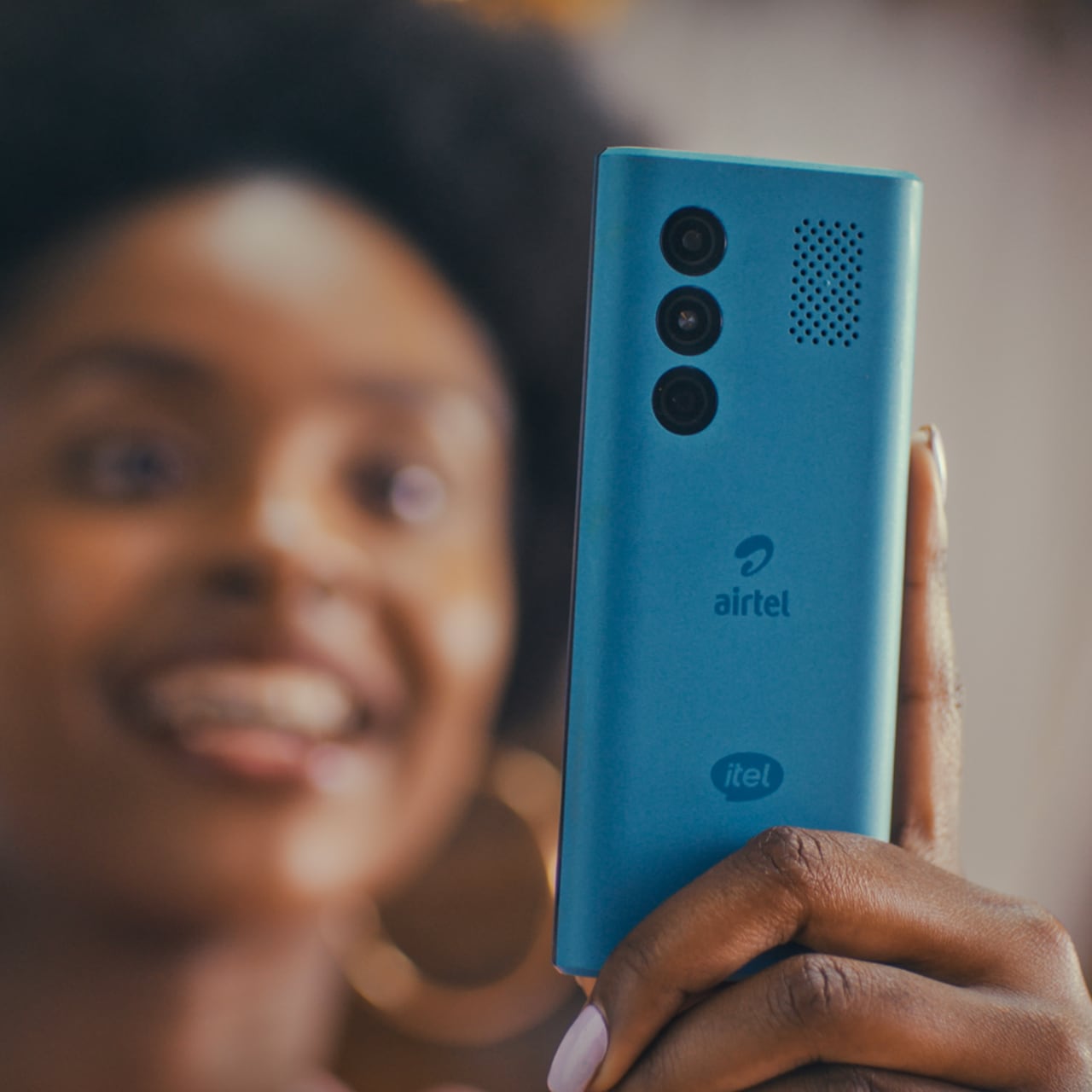 Woman smiling while looking at her phone