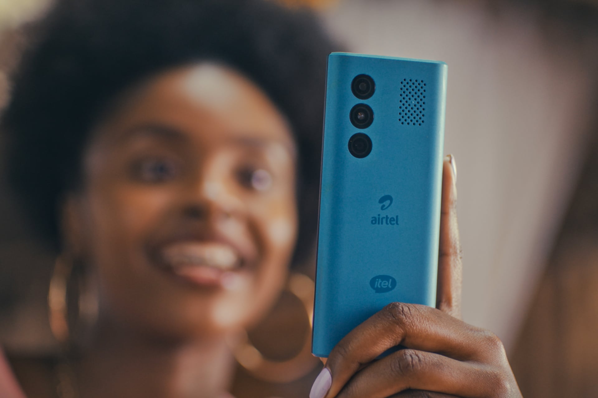 Woman smiling while looking at her phone