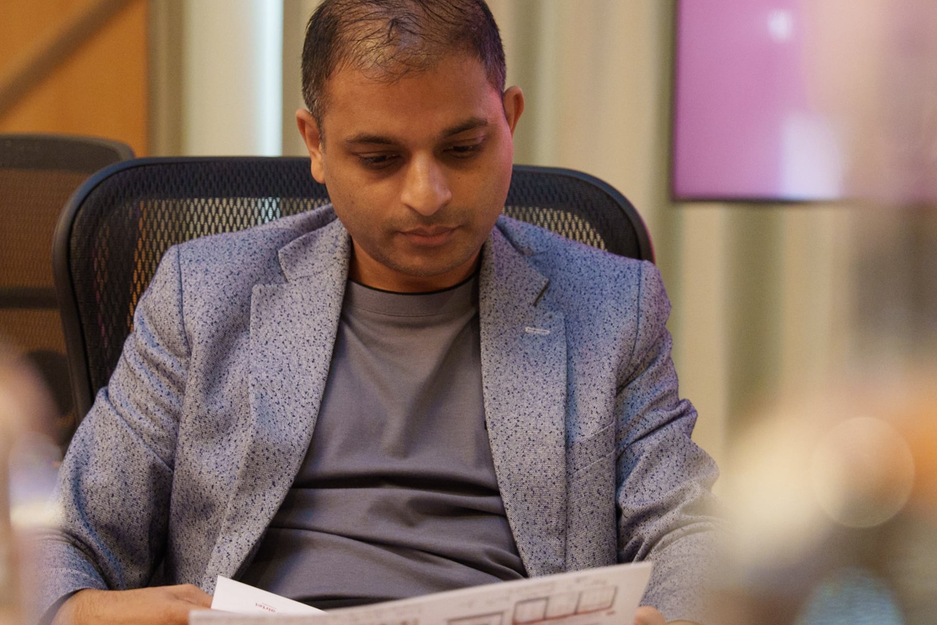 Ian Ferrao reading while sat at a desk