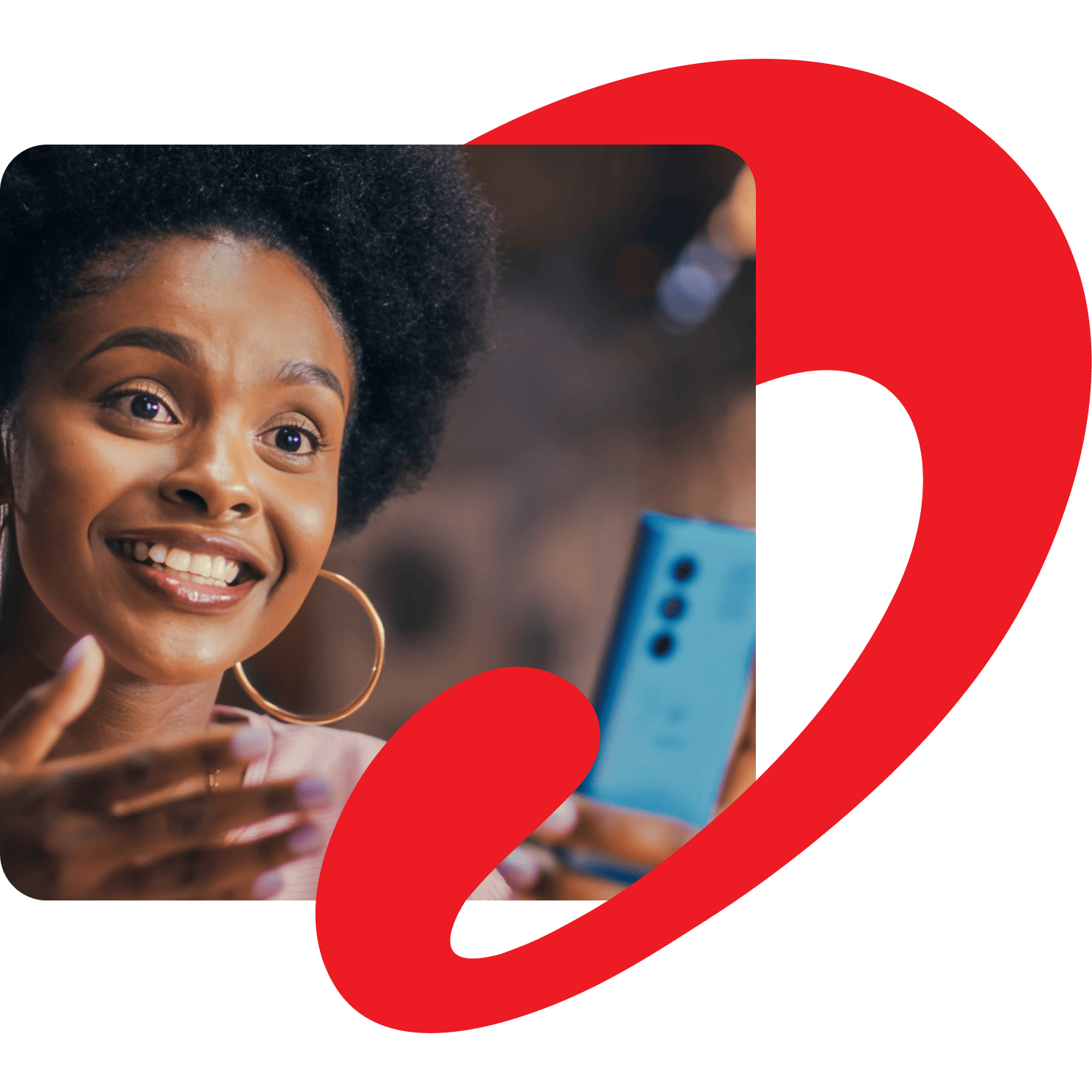 Woman in conversation with someone at the dinner table while holding a mobile phone