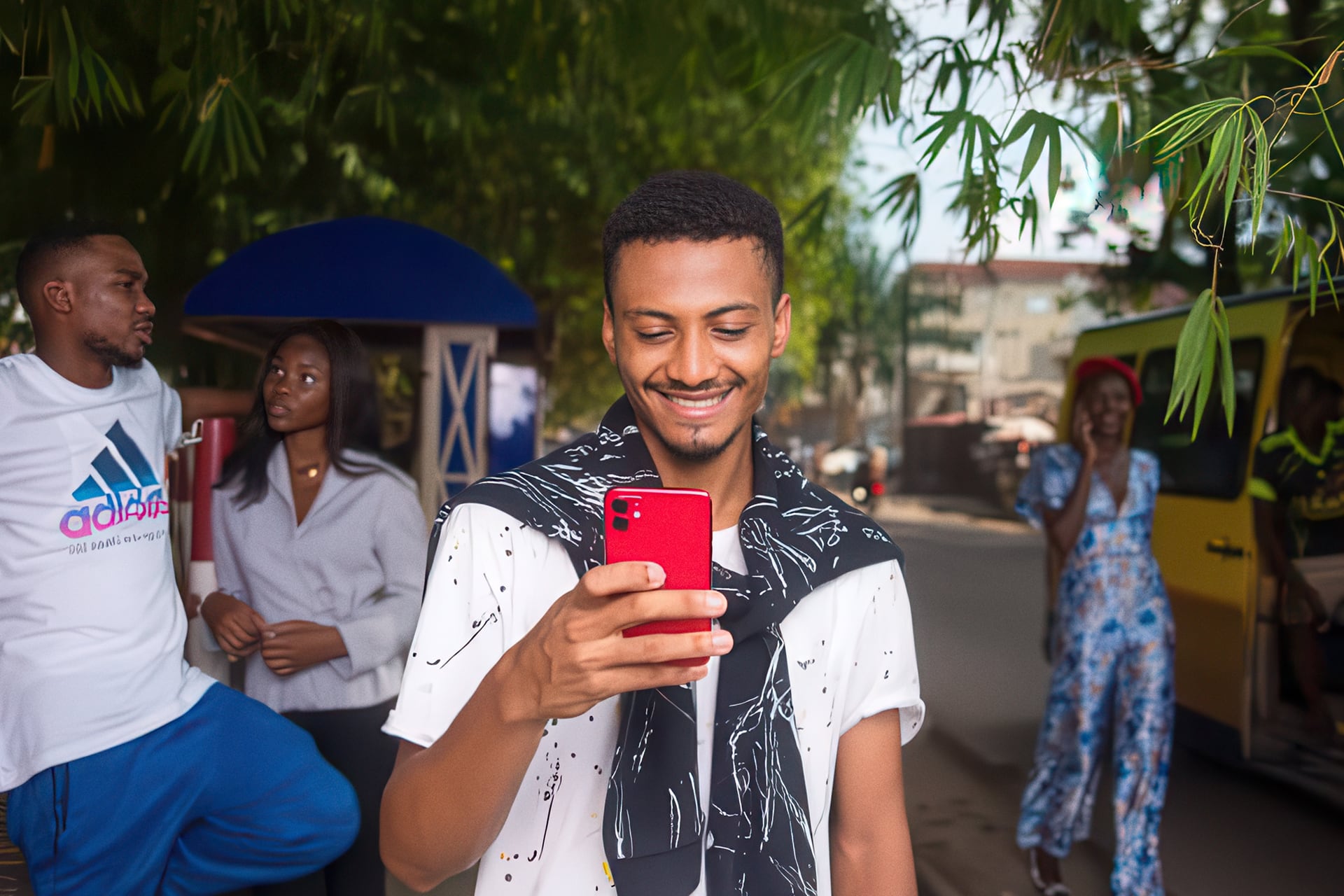 Young man looking at his phone while walking down a busy street