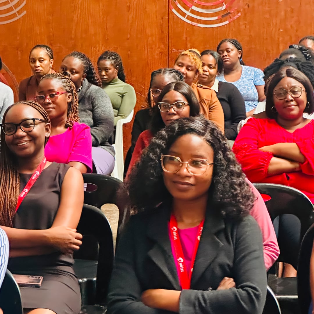 An audience made up of women looking ahead at something outside of the shot