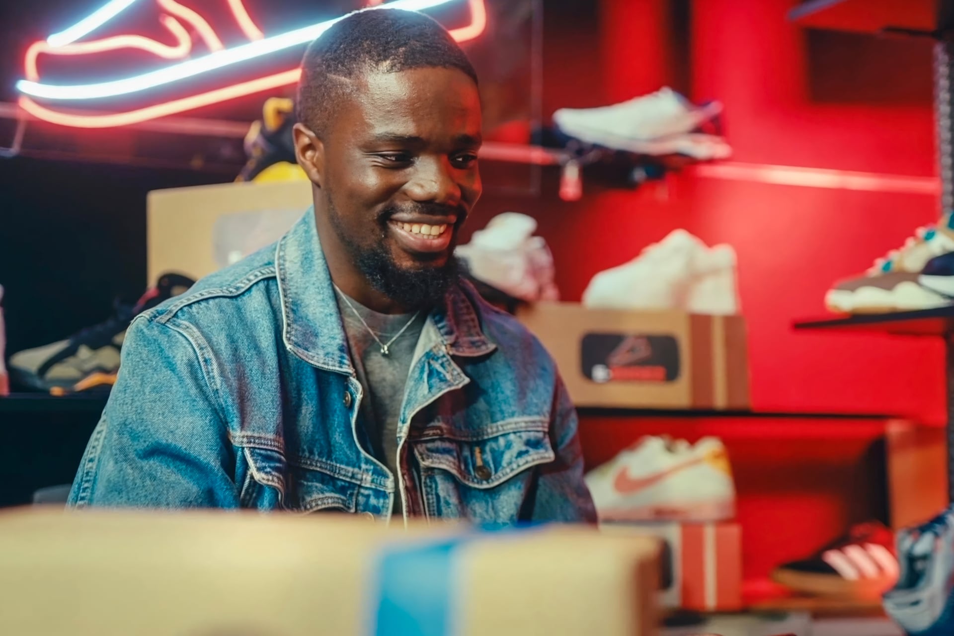 Man smiling while working in a shoe shop