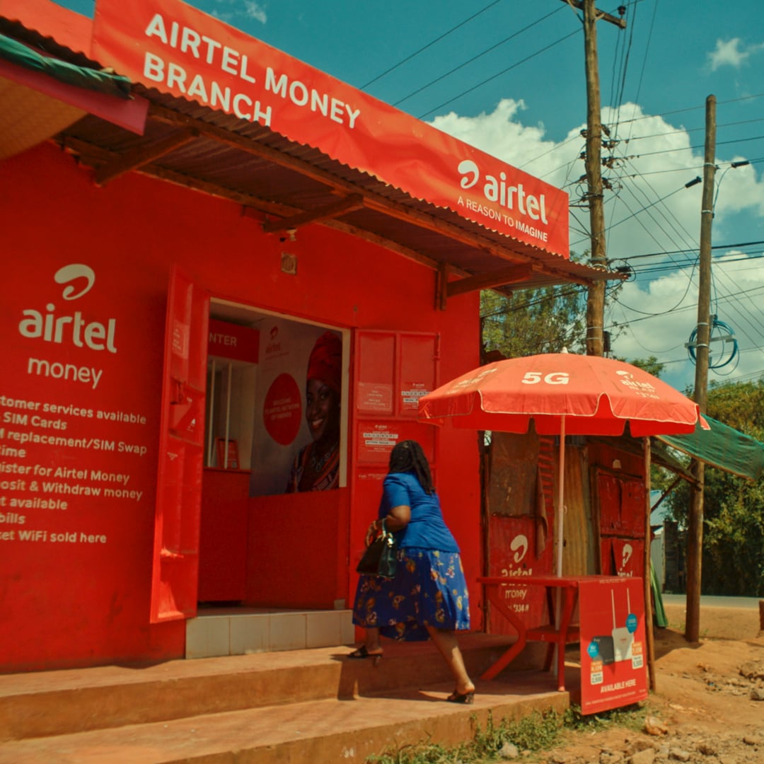 A woman entering an Airtel kiosk