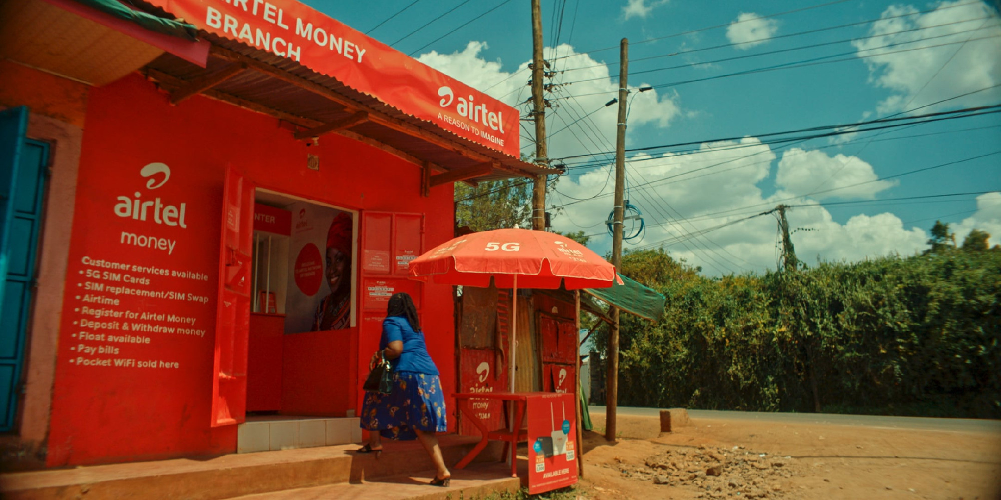 A woman entering an Airtel kiosk