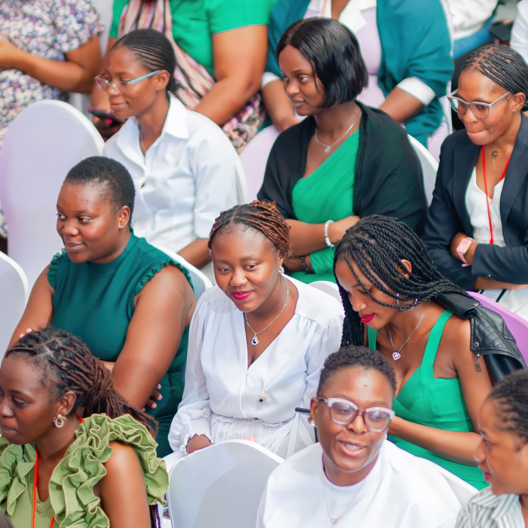 A group audience of women in predominantly green clothing