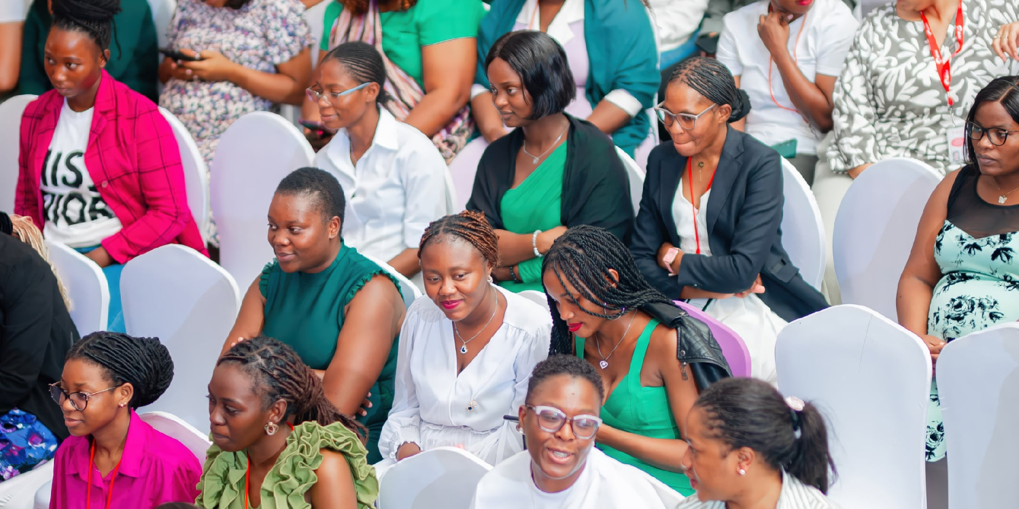 Shot down onto an audience made up of women in predominantly green clothing