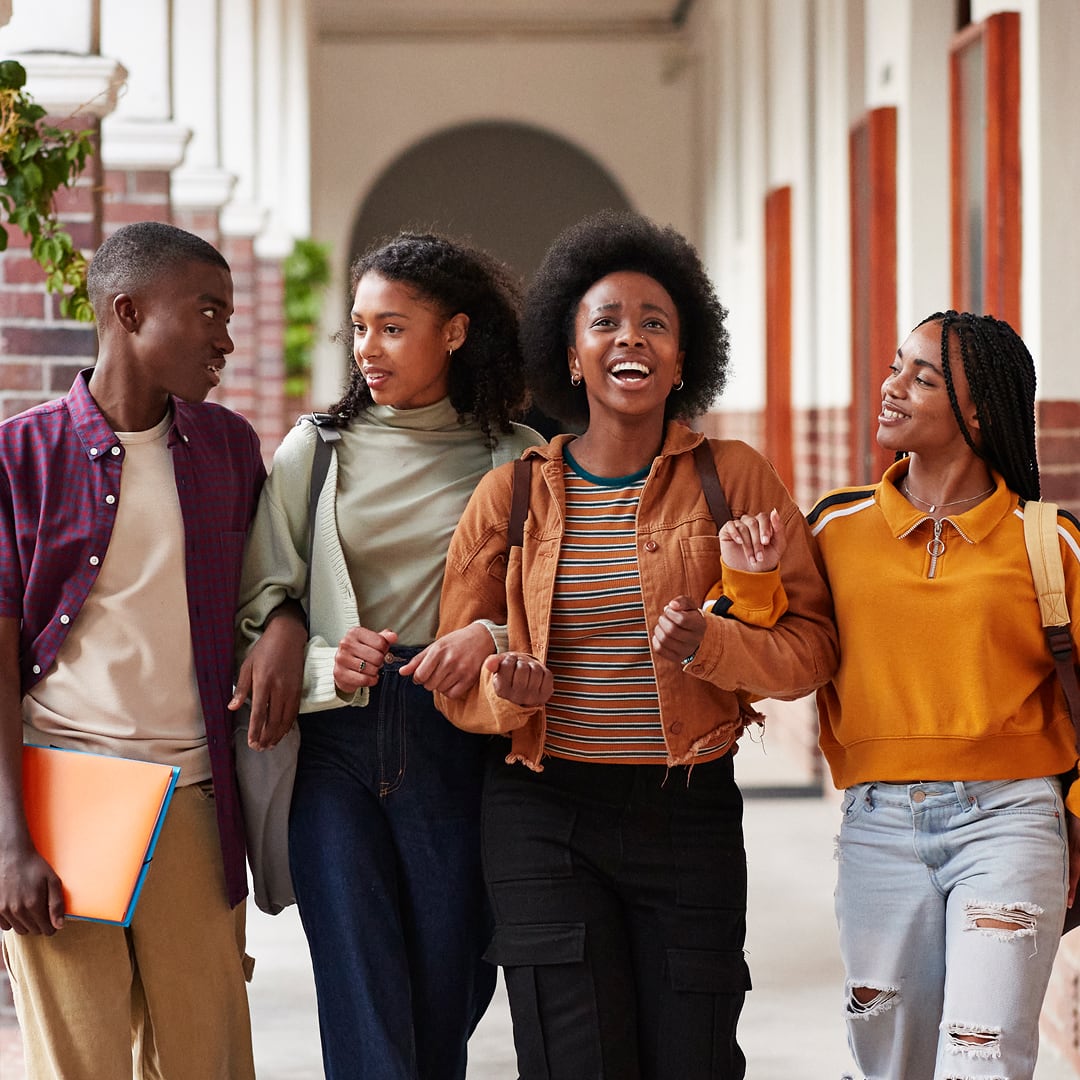 Young African college friends walking together