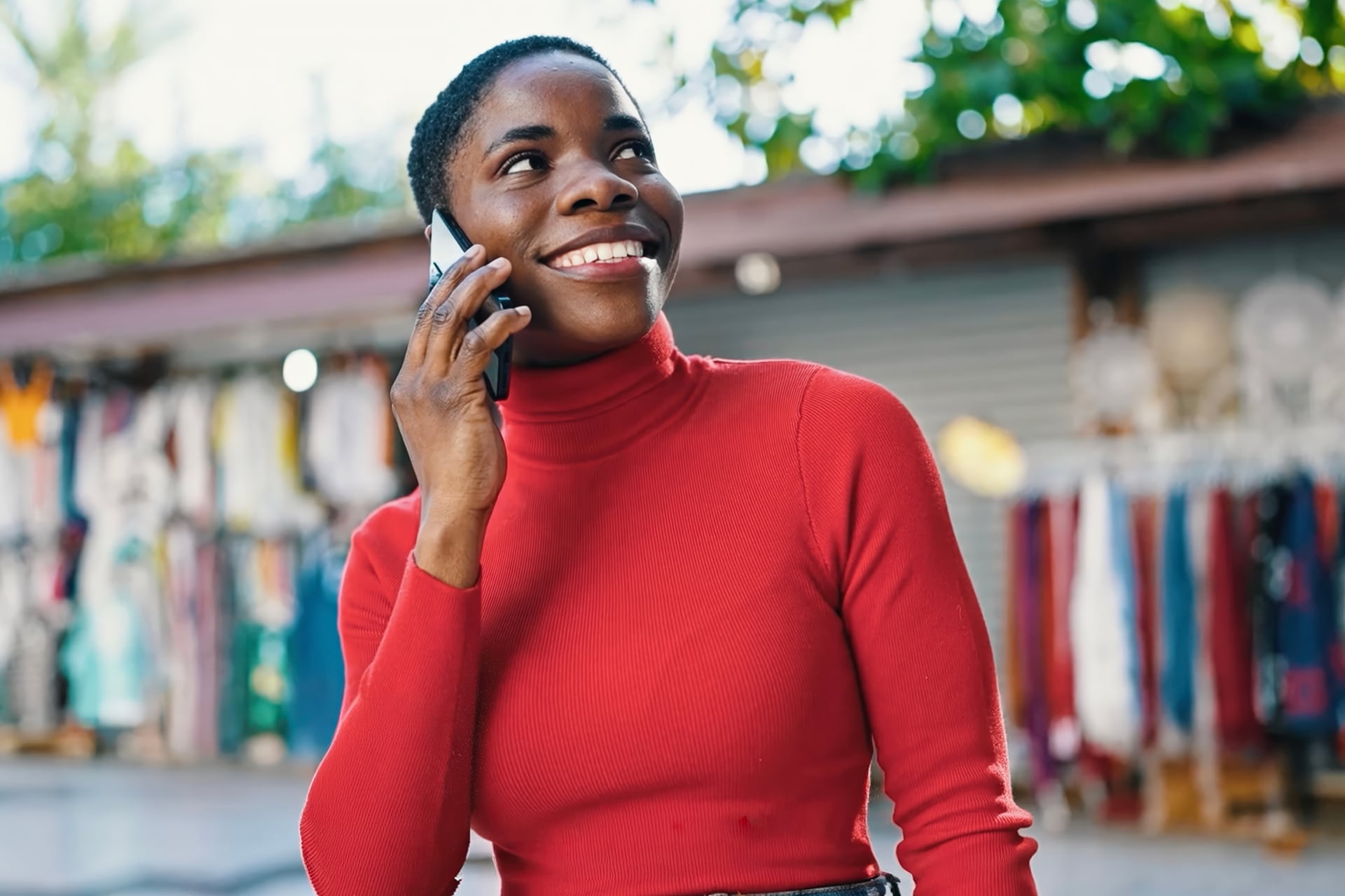 Woman smiling with her phone held against her ear